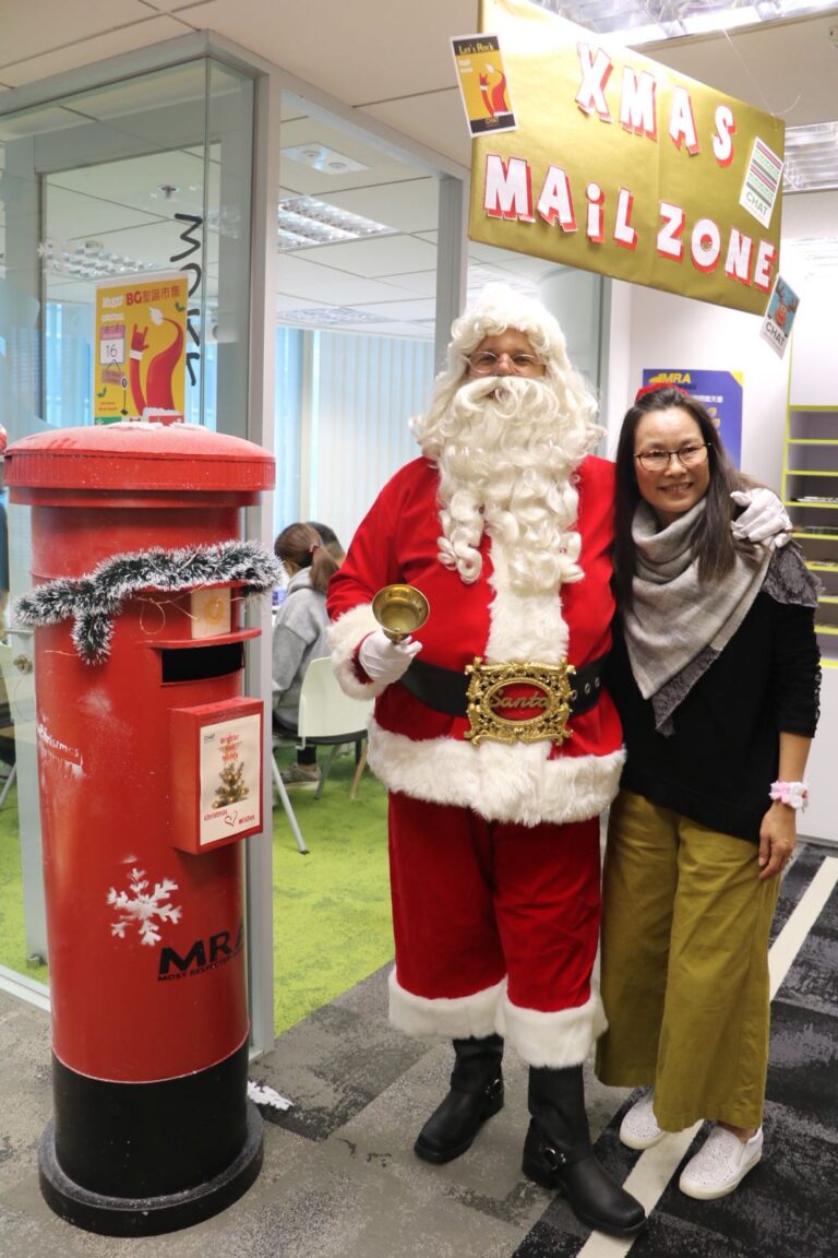Santa standing next to a Xmas post box