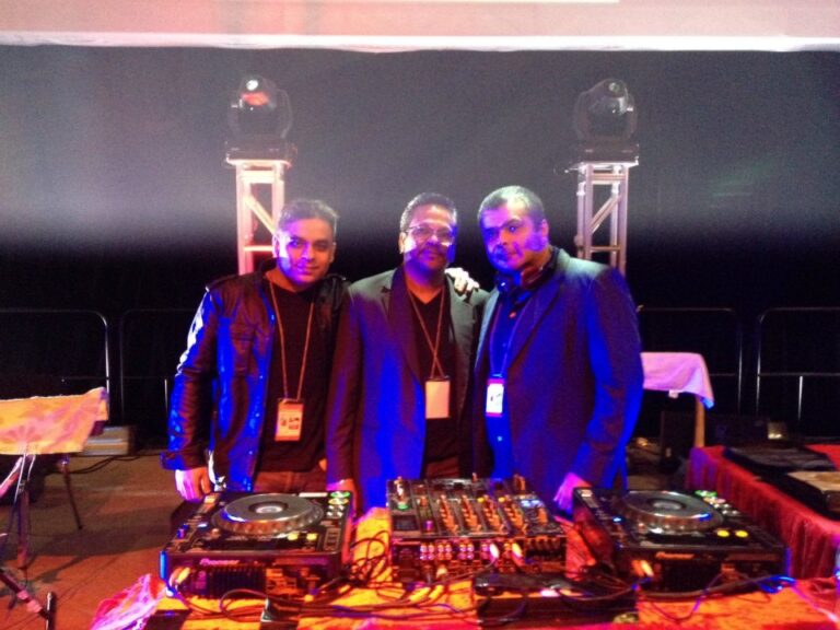 DJ V and two men take picture in Hong Kong
