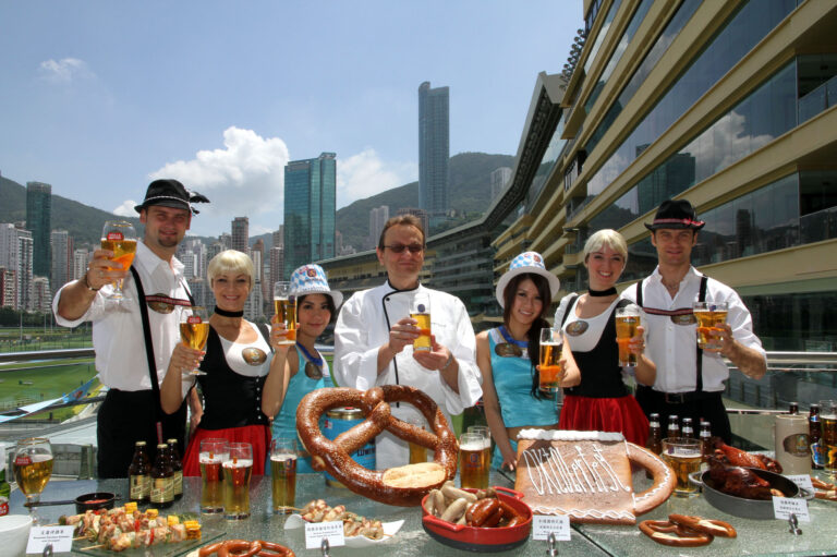Four dancers in Hong Kong wearing German traditional costume posing for the Hong Kong Jockey Club Oktoberfest event