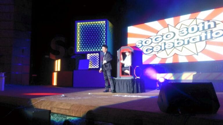 Magician performing stage magic with the audience inside the magic box at the Hong Kong SOGO 30th anniversary corporate dinner