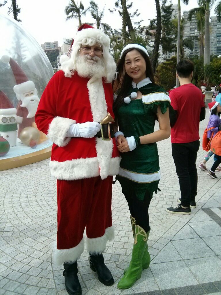 santa hong kong standing next to elf