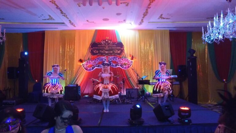 Three Dancers in Maries Marionette LED costume performing stage dance performance at a corporate annual dinner