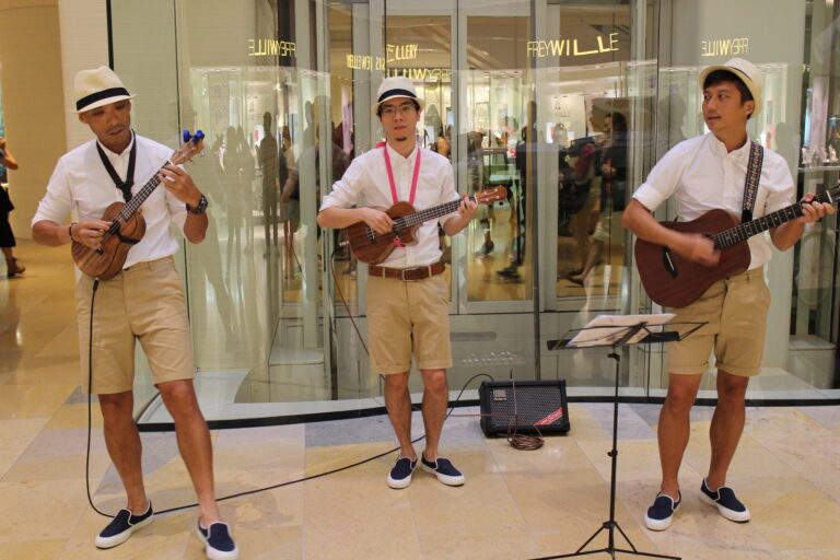 Three Ukulele players performing in Hong Kong shopping mall