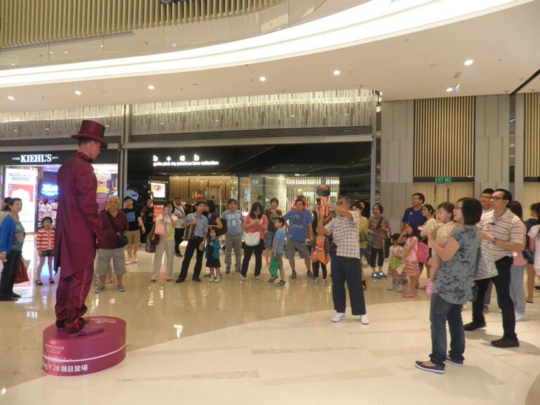 Purple Living State performing in shopping center with crowd behind