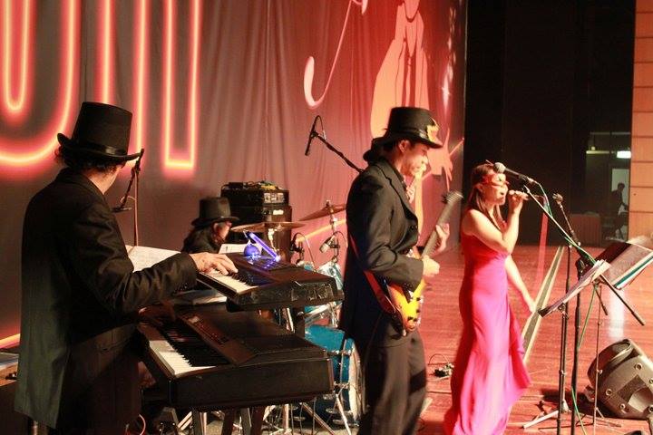 Singer in HK wearing pink , performing with live band at a annual event