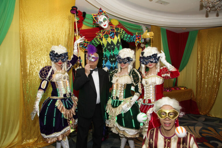 Stiltwalker in Venetian LED costume posing with three Maries Marionette dancers and juggler at a Hong Kong corporate Masquerade theme event