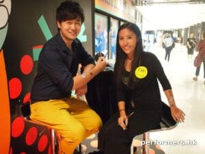 Face painter in HK taking picture with the guest after she finished her painting at a shopping mall Halloween event