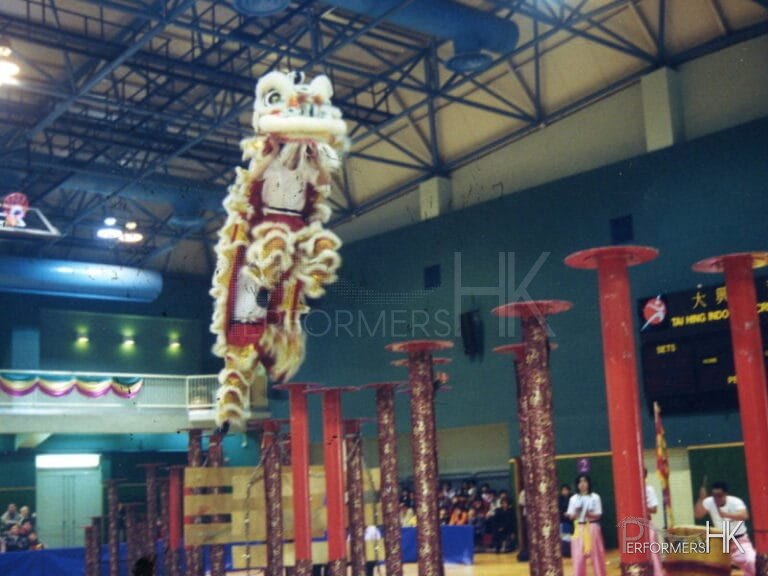 Lion jumps from one pole to another in Lion dance performance in Hong Kong