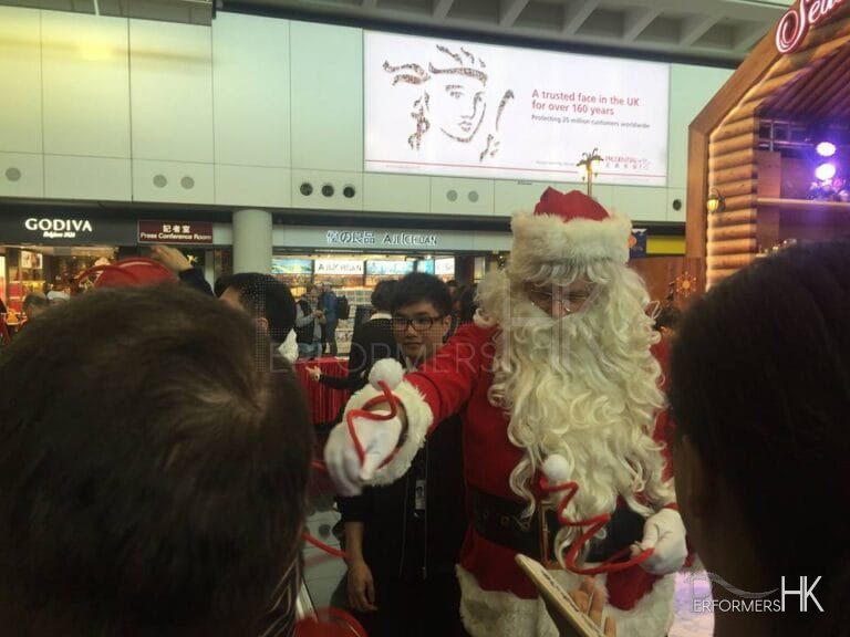The Santa performer in HK giving out Christmas giveaway at the Hong Kong airport Xmas Event.