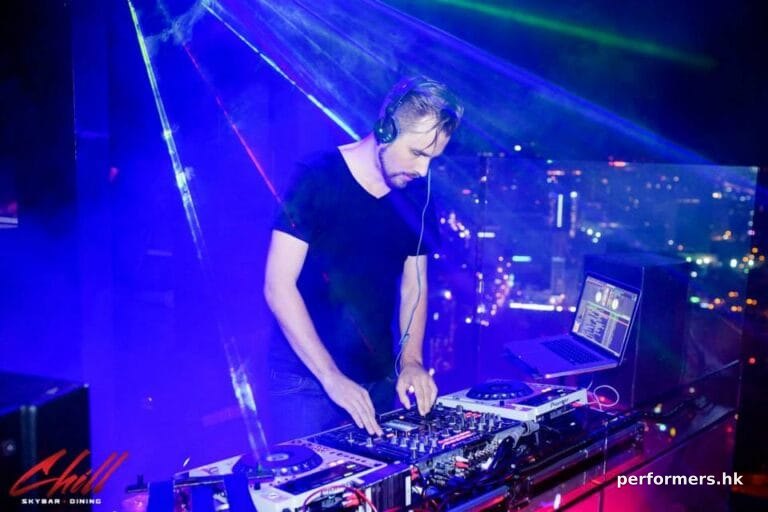 Professional DJ Pure MB makes music in Hong Kong under blue light