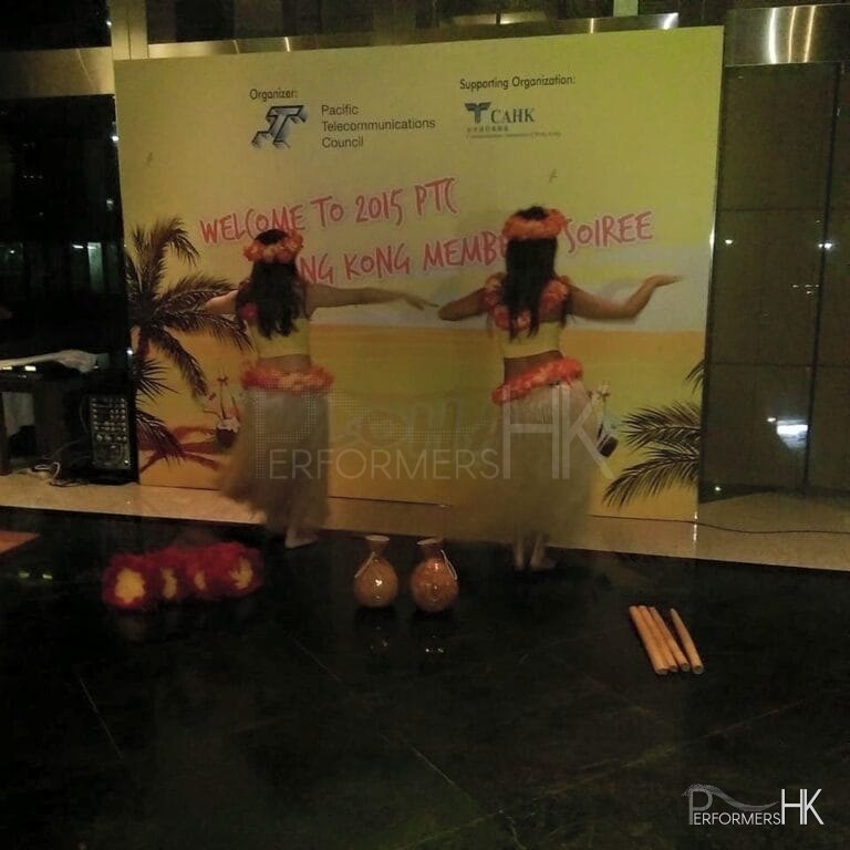 2 dancers doing the hula in front of backdrop for event in Hong Kong