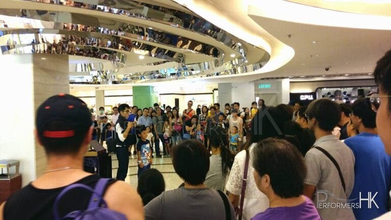 Hong Kong roving magician performing magic with a big audience at a Hong Kong shopping mall