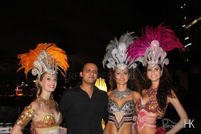 Three Brazilian Dancers Roving meet and greet a gentleman at corporate function for Hong Kong Indian Association