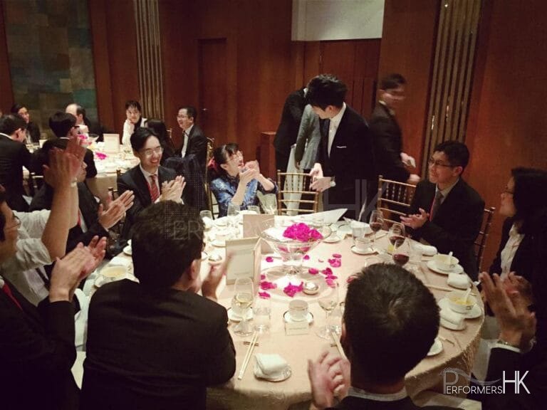 Magician in Hong Kong performing table magic with cards to a lady at a corporate annual dinner
