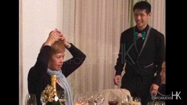 Hong Kong roving juggler teaching a guest to do the crystal ball trick at an annual dinner