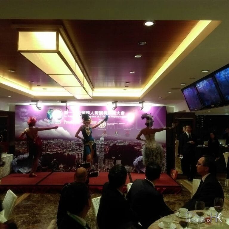 3 dance posing in front of backdrop