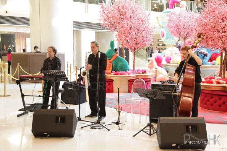 3 musicians playing in mall in HK. Sax, double bass, Keyboard trio