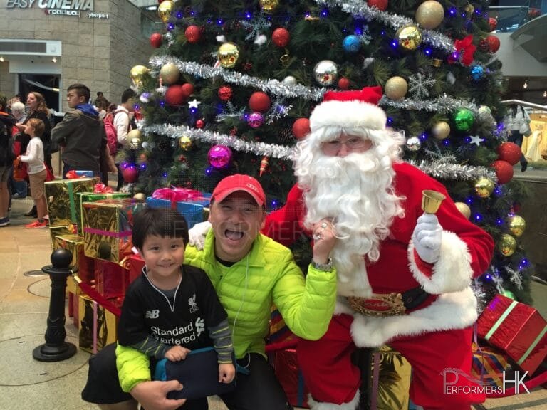 Santa standing infront of giant tree