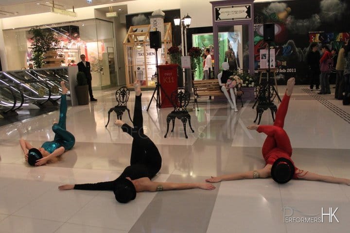 3 dancers on the floor of the shopping mall performing