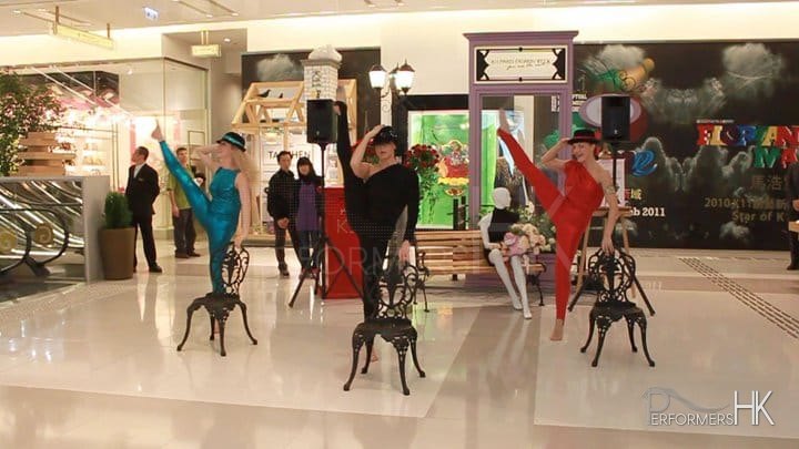 Modern dance performance in Hong Kong shopping mall with three dancers in hats