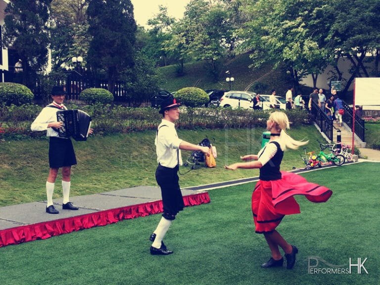 German dancing pair at a park in Hong Kong performing with music