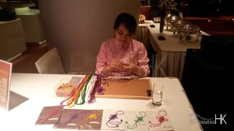 Hong Kong artist knitting Chinese knotting at a corporate event