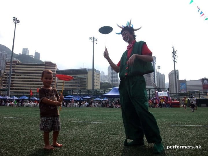 Hong Kong roving clown juggler spinning a circus plate with a guest at a corporate event in HK Football Club
