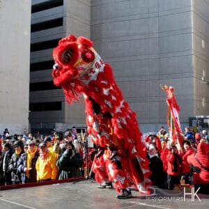 Hong Kong Dancer performing Lion Dance with the Red Lion on the street for a Chinese new year corporate event