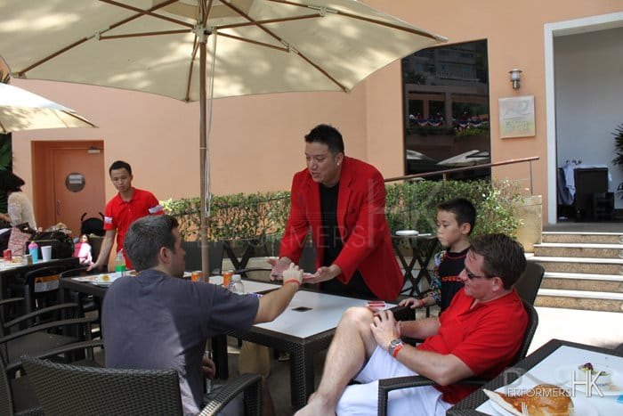 Magician at The Independent day corporate function performing roving magic and invited a gentlemen to pick a card at the American club Hong Kong