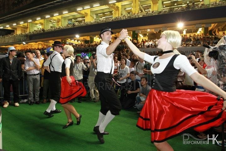 huge group of audience in Hong Kong jockey club watching four German dancers dancing at Oktoberfest Celebrations