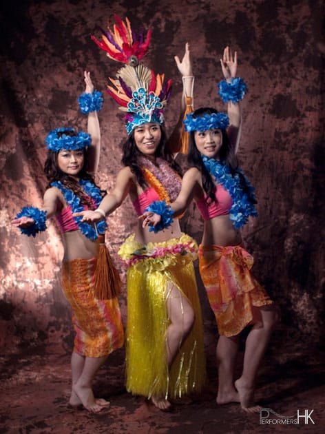 3 island dancers posing in costumes for photoshoot