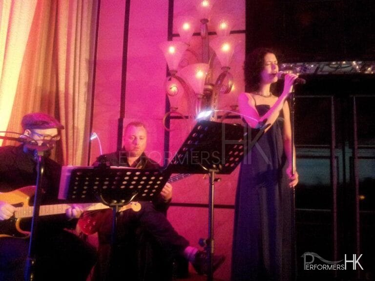 Singer in Hong Kong performing with three musician at a annual dinner in a hotel