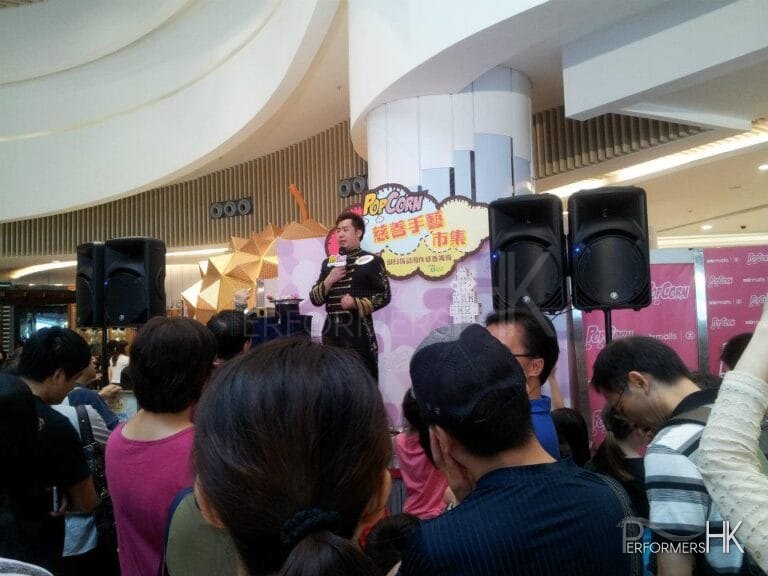 Magician performing stage magic with a mic at Hong Kong Shopping mall