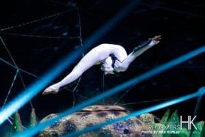 HK Contortion performer holding herself up on a stick with her mouth at a corporate annual dinner party