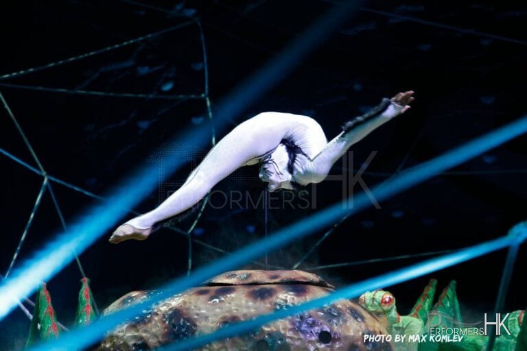 HK Contortion performer holding herself up on a stick with her mouth at a corporate annual dinner party