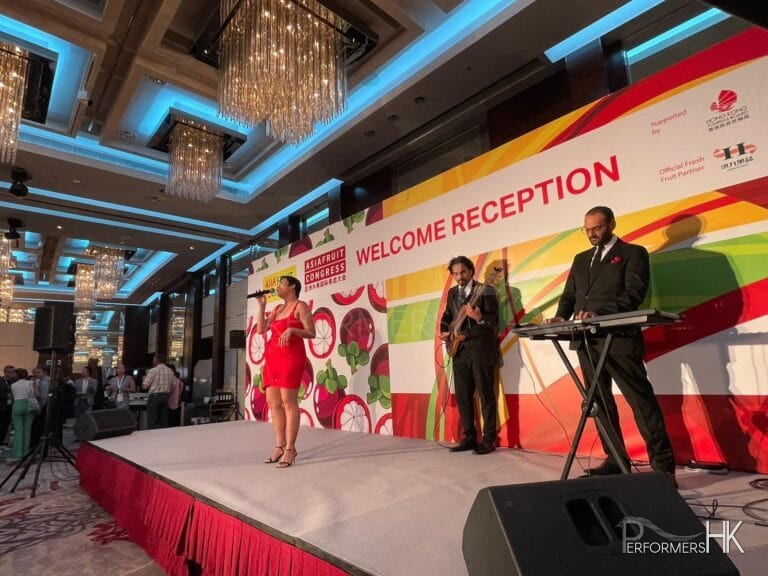 recently mentioned event by financial sec. of Hong Kong; Asia fruit logistica with singer and 2 musician on stage in black suit and red dress respectively