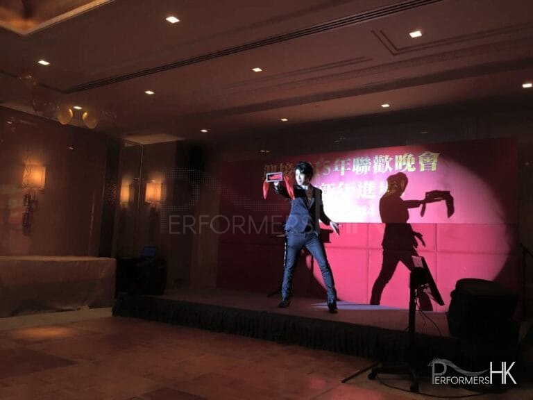 Magician performing stage magic with a box and silk at a Hong Kong corporate annual dinner