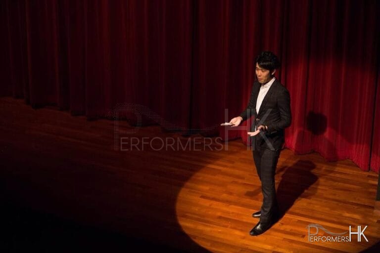 Hong Kong Magician performing stage magic with a spotlight on him at corporate annual dinner
