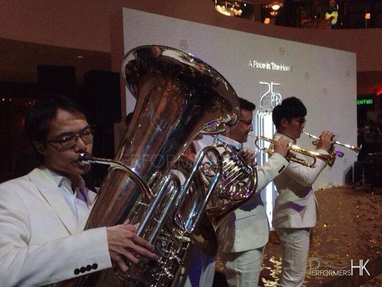band featuring trumpet and horn performing in white suits