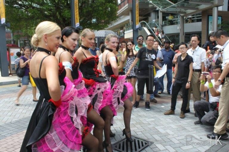 Dancers in pink costume posing for photos in Hong Kong