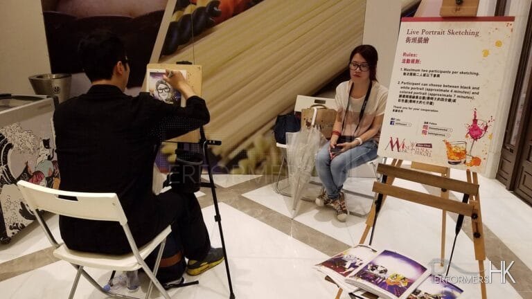 Girl waiting for her drawing to be done with Performers Hk Caricaturist