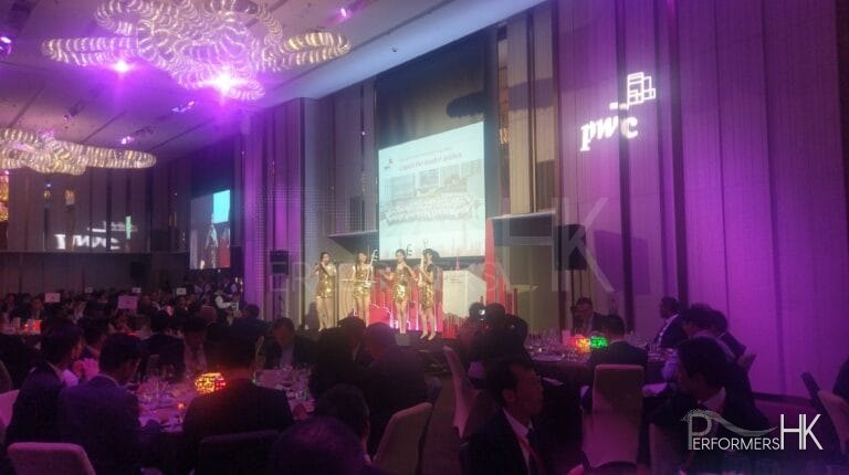 4 girls in gold costume performing on stage