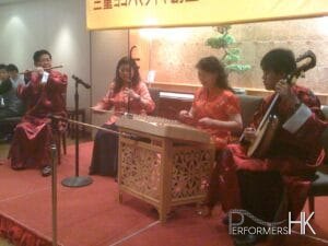 Four Chinese musicians performing at a dinner event