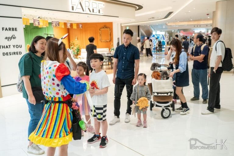 queues forming shoppers waiting patiently for Cory to twist her excellent balloons