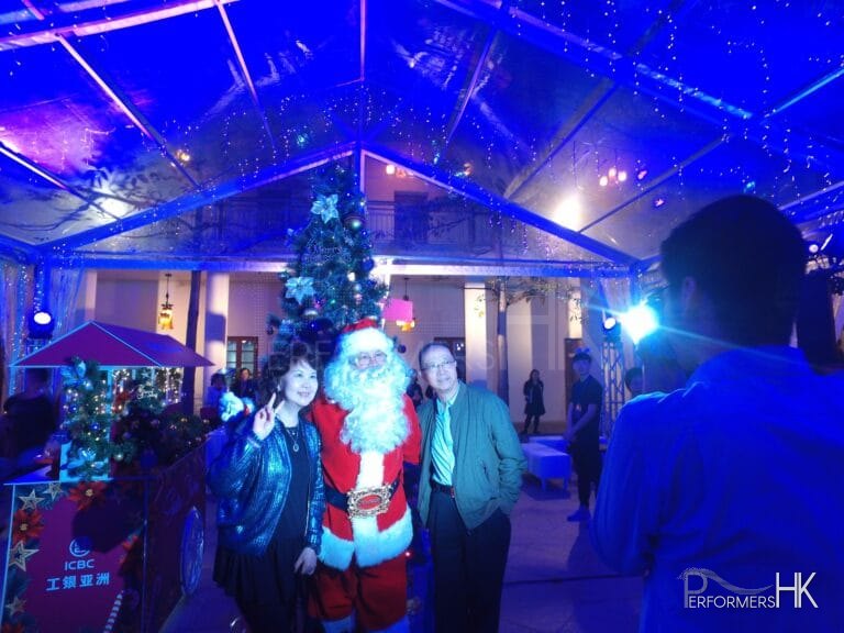 Santa taking photo in marquee.