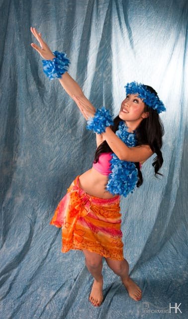Female hula dancer in Hong Kong dressed in orange and blue
