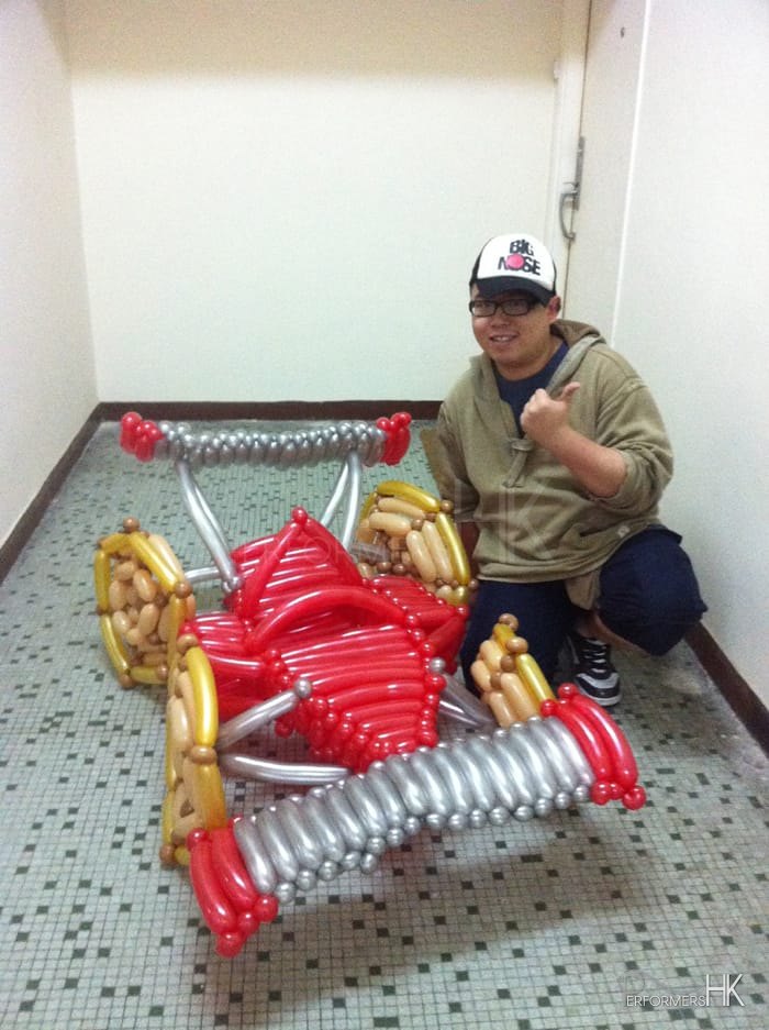 Hong Kong Roving balloons twister with his Red and sliver balloons race car for a corporate event