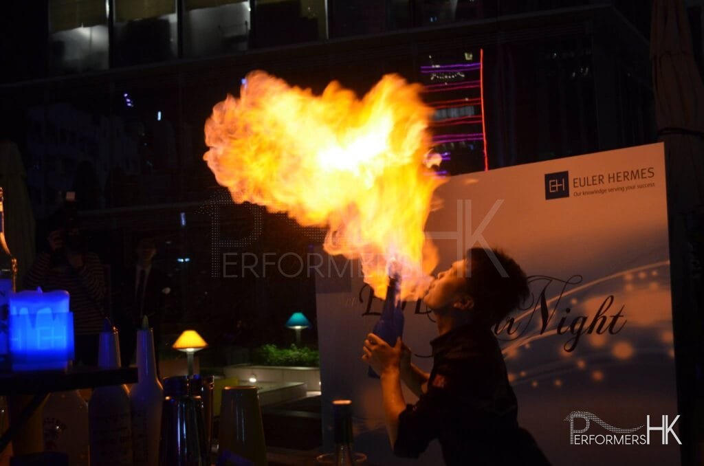 bartender blowing fire at a corporate event mixing cocktails