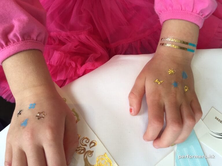 A Hong Kong Kid have ten henna style temporary  tattoos on her hands at a family function