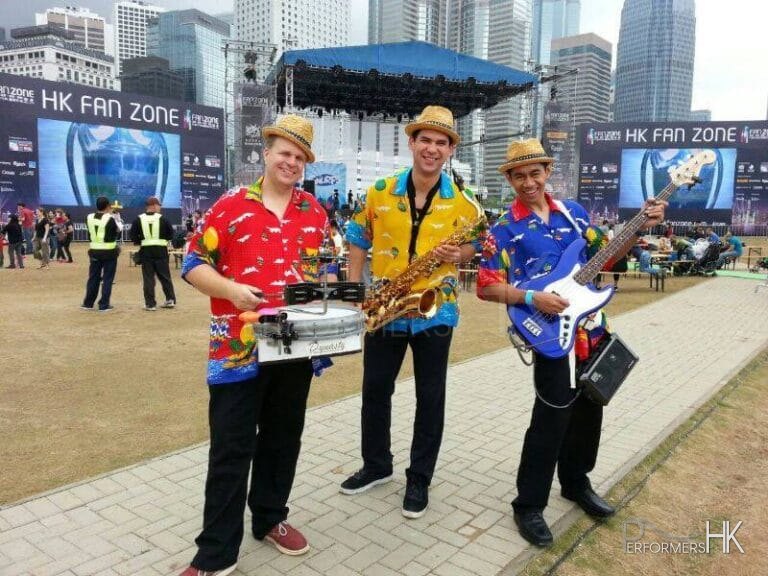 3 musicians in Hong Kong walk around performing at a summer event